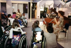 Children are transfixed by the music of Kim Gilad at Children's Hospital of Los Angeles