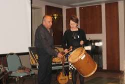 Pepe Santana demonstrates the use of a drumlin his music of the Andes at a conference