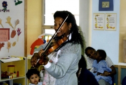 Violinist Marisa McLeod works with the children at House of Ruth  in California